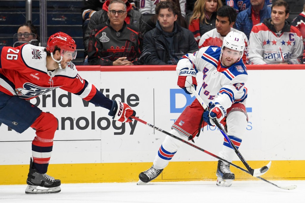 New York Rangers left wing Conor Sheary (43) passes the puck defended by Washington Capitals center Nic Dowd (26) during the first period at Capital One Arena. 
