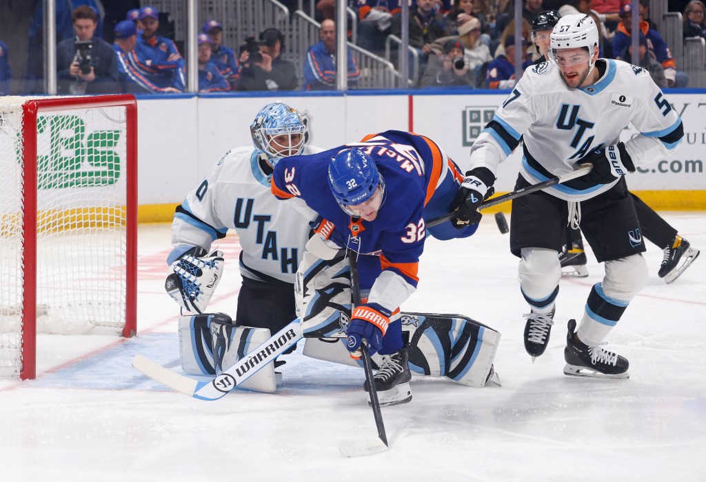 Kyle MacLean #32 of the New York Islanders falls over after he tries to tip in the puck as Karel Vejmelka #70 of the Utah Mammoth and Nick Desimone #57 of the Utah Mammoth defend during the first period when the New York Islanders played the Utah Mammoth Thursday, January 1, 2026 at UBS Arena in Elmont, NY. 