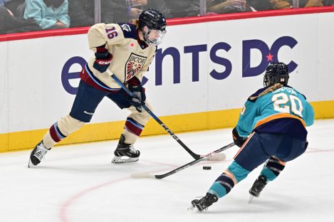 WASHINGTON DC, JANUARY 18: Forward Hayley Scamurra (16) of the Montreal Victoire tries to stickhandle around Defender Allyson Simpson (20) of the New York Sirens during the first period of the PWHL Takeover Tour game between the Montreal Victoire and New York Sirens on January 18, 2026 at Capital One Arena in Washington, DC. (Photo: Robert Raymer)