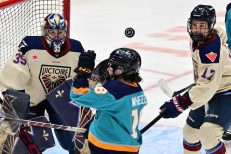 WASHINGTON DC, JANUARY 18: Goaltender Ann-Renee Desbiens (35) of the Montreal Victoire and Forward Dara Greig (17) of the Montreal Victoire focus on the puck as it deflects above Forward Maddi Wheeler (18) of the New York Sirens’ head during the third period of the PWHL Takeover Tour game between the Montreal Victoire and New York Sirens on January 18, 2026 at Capital One Arena in Washington, DC. (Photo: Robert Raymer)