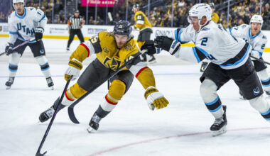 Golden Knights defenseman Noah Hanifin (15) gets a stick from Utah Mammoth defenseman Olli M&#x ...