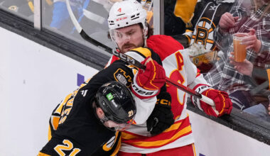 Calgary Flames defenseman Rasmus Andersson (4) tangles with Boston Bruins center Alex Steeves ( ...