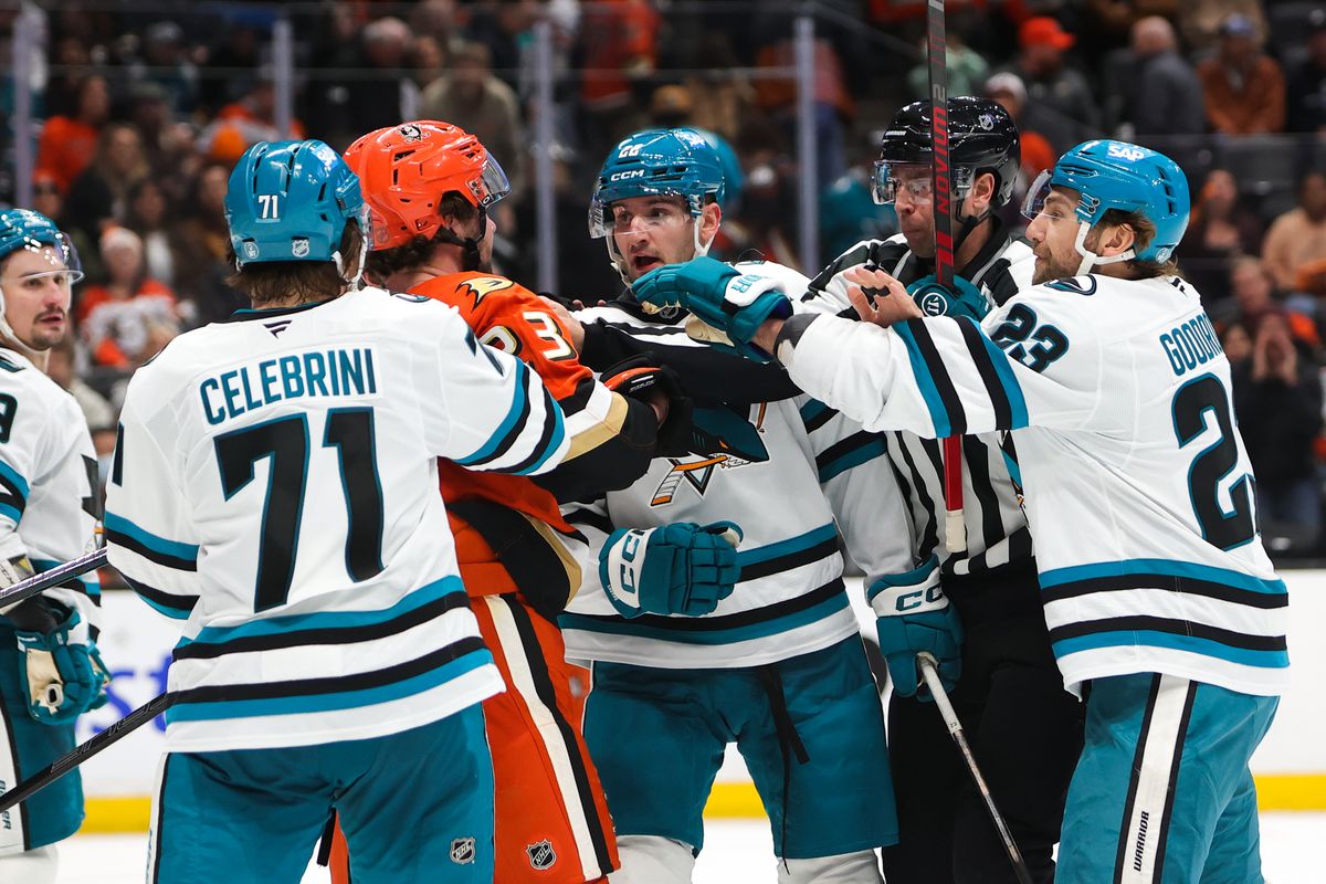 Teammates and officials attempt to break up a fight during an NHL game between the Anaheim Ducks and the San Jose Sharks on December 29, 2025 in Anaheim, CA.