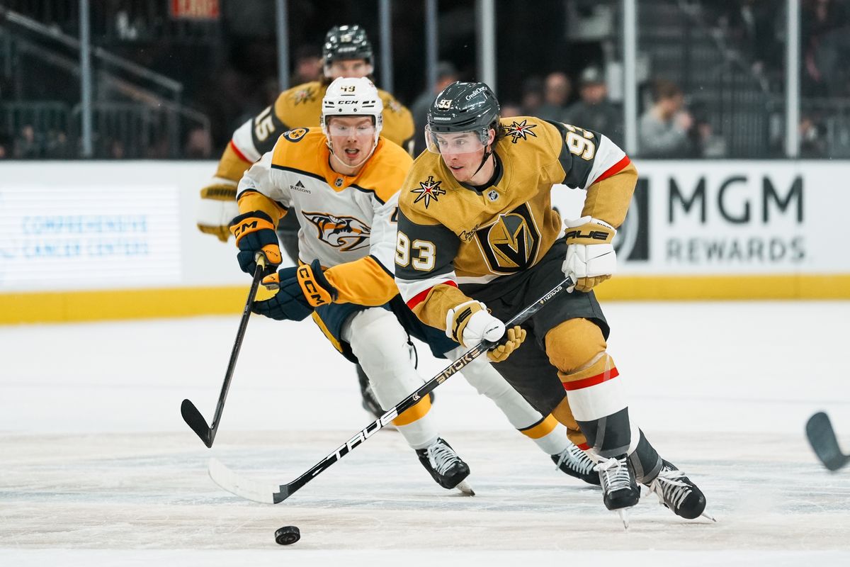 Vegas Golden Knights right wing Mitch Marner (93) tries to escape left wing Reid Schaefer (49) while skating the puck down the ice during first period of NHL game against Nashville Predators on Wed. Dec. 31, 2025 at T-Mobile Arena in Las Vegas. Vegas Golden Knights right wing Mitch Marner (93) tries to escape left wing Reid Schaefer (49) while skating the puck down the ice during first period of NHL game against Nashville Predators on Wed. Dec. 31, 2025 at T-Mobile Arena in Las Vegas.