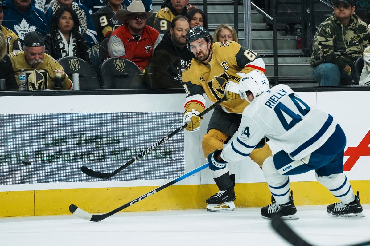 Vegas Golden Knights right wing Mark Stone (61) passes the puck past Maple Leafs defensemen Morgan Rielly (44) during first period of NHL game against Toronto Maple Leafs on Thursday Jan. 15, 2026 at T-Mobile Arena in Las Vegas.