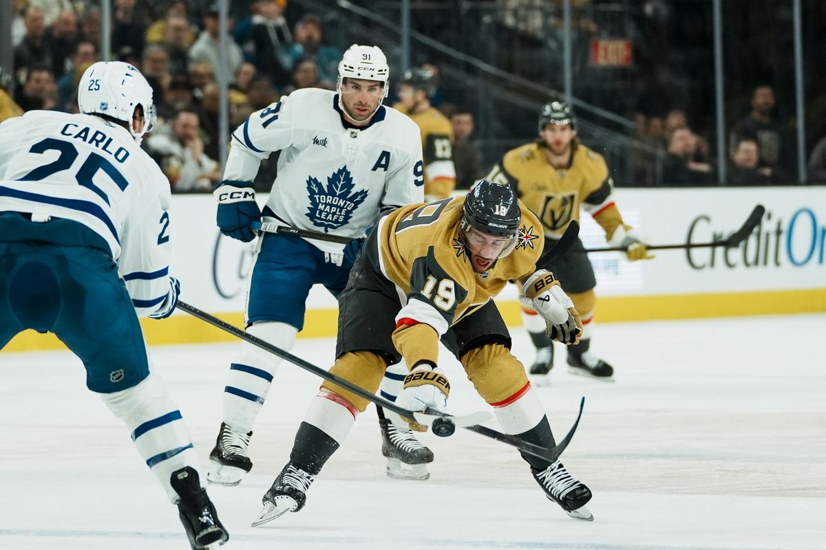 Vegas Golden Knights right wing Reilly Smith (19) hits the puck down infant of Maple Leafs center John Tavares (91) during NHL game against Toronto Maple Leafs game on Thursday Jan. 15, 2026 at T-Mobile Arena in Las Vegas.