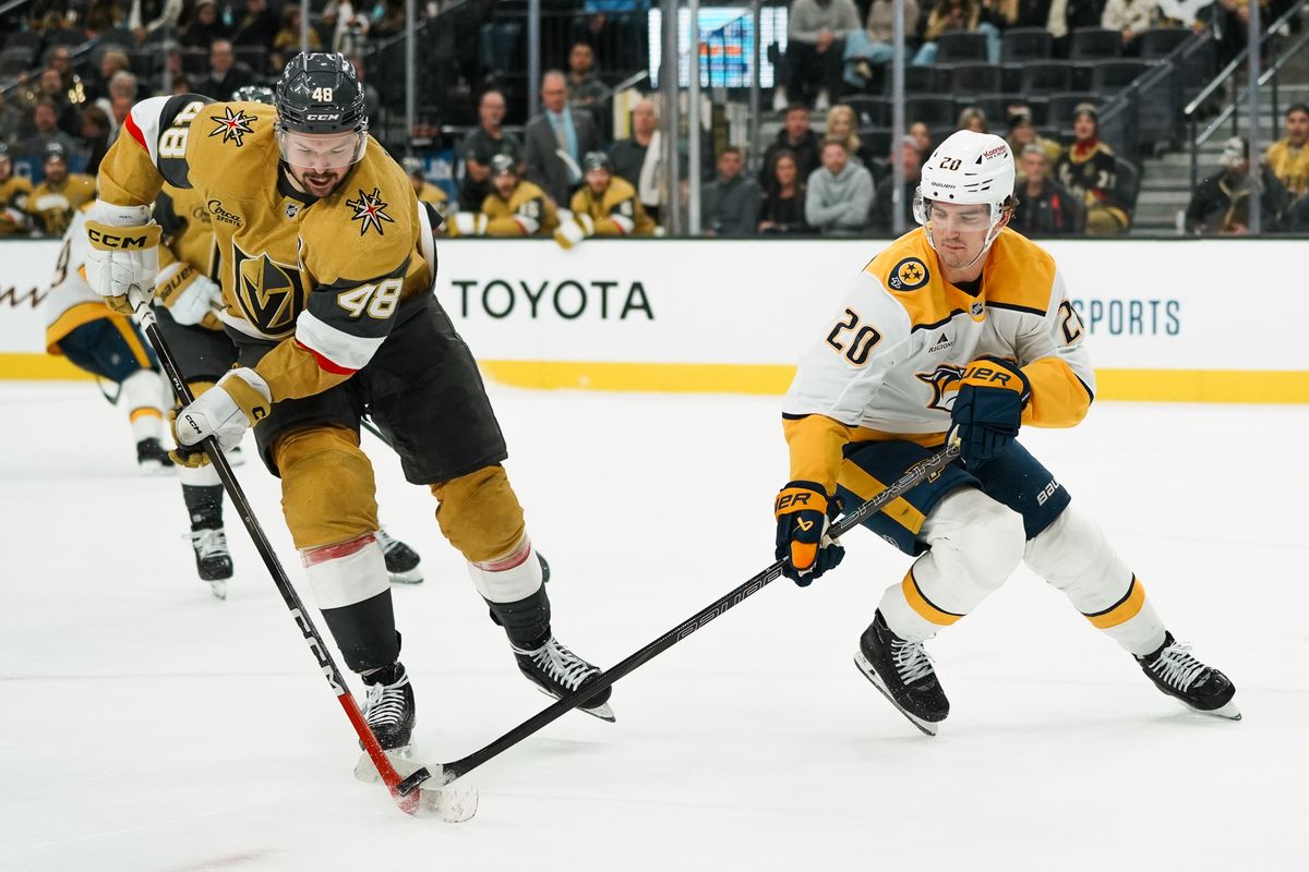Vegas Golden Knights center Tomas Hertl (48) and Nashville Predators defenseman Justin Barron (20) reach for the puck during third period of NHL game against Nashville Predators on Saturday Jan. 17, 2026 at T-Mobile Arena in Las Vegas.
