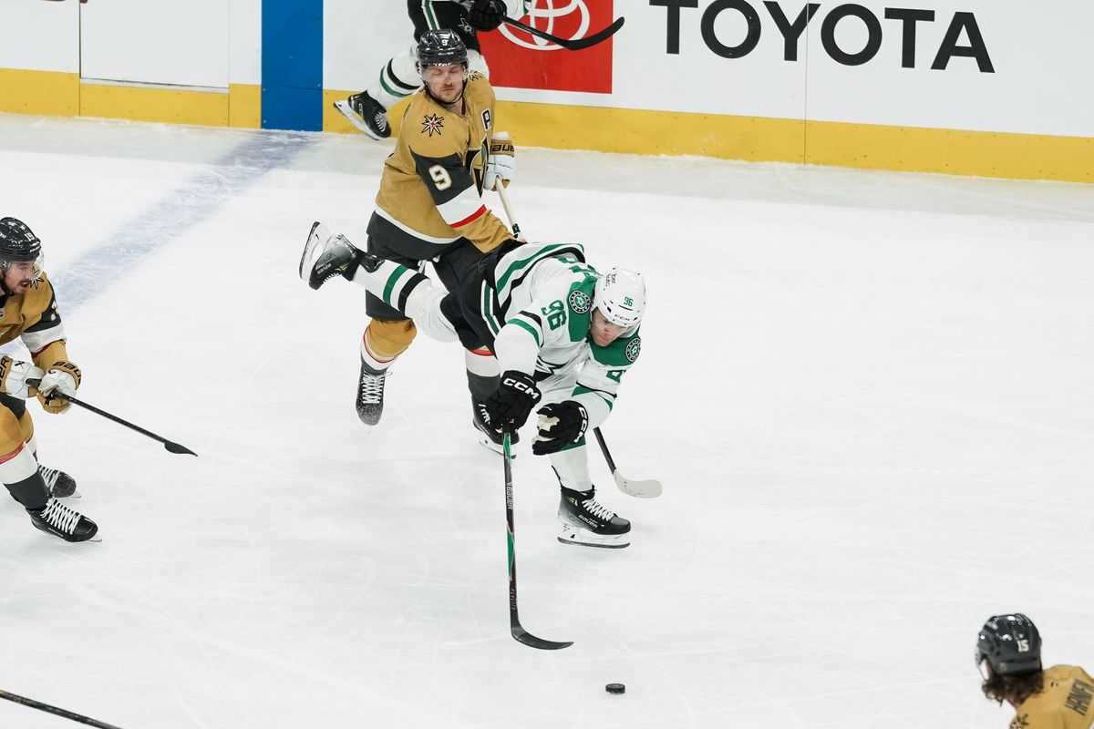 Dallas Stars right wing Mikko Rantanen (96) reaches for the puck while  Golden Knights center Jack Eichel (9) skates behind him during first period of NHL game against Vegas Golden Knights on Thursday Jan. 29, 2026 at T-Mobile Arena in Las Vegas.