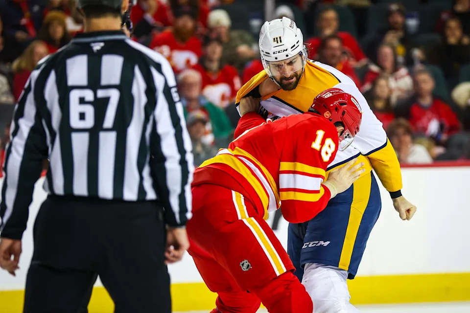 Jan 3, 2026; Calgary, Alberta, CAN; Nashville Predators defenseman Nicolas Hague (41) and Calgary Flames center John Beecher (18) fight during the second period at Scotiabank Saddledome. Mandatory Credit: Sergei Belski-Imagn Images