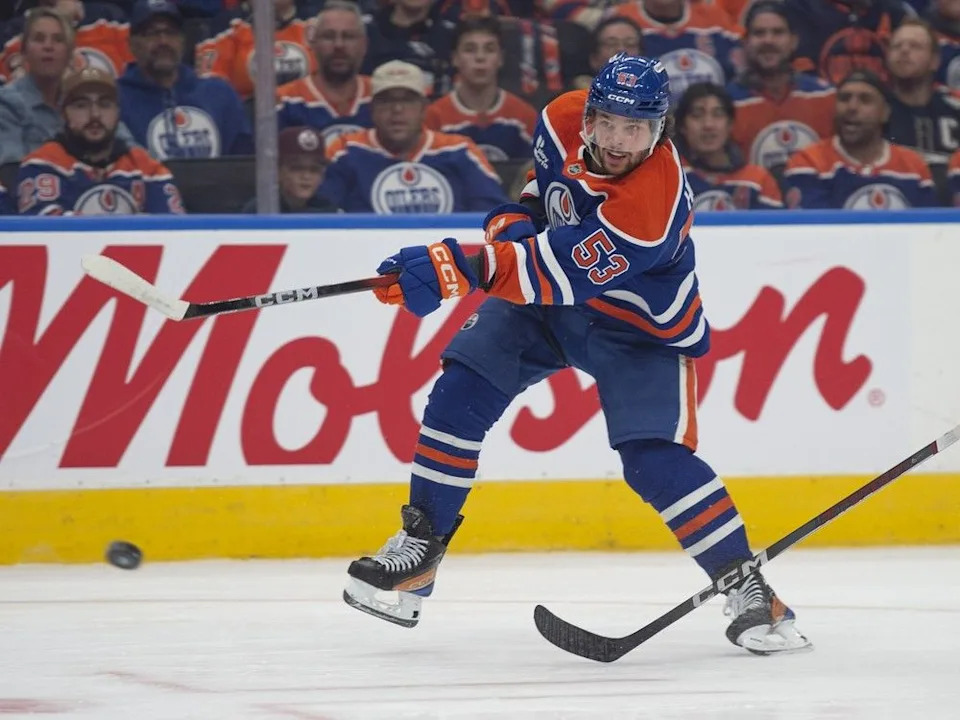Ike Howard (53) of the Edmonton Oilers shoots the puck against the Calgary Flames at Rogers Place in Edmonton on Wednesday, Oct. 8, 2025.