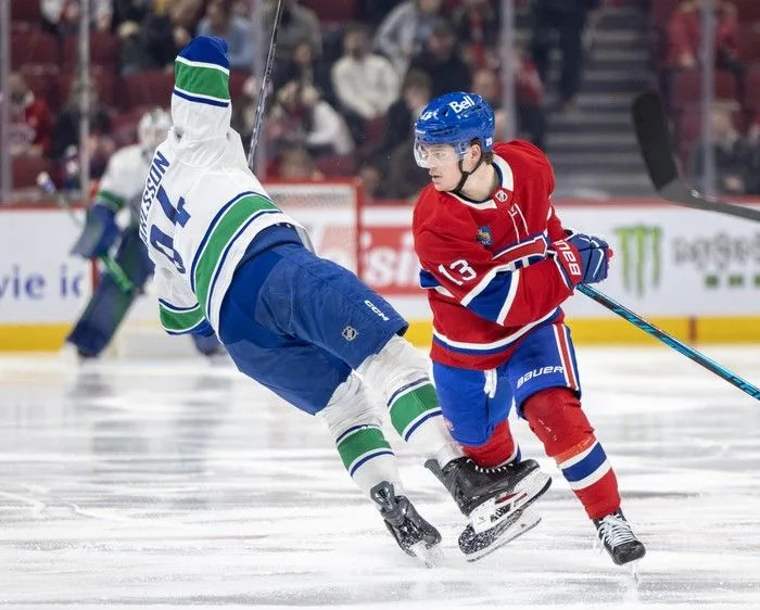  Montreal Canadiens’ Cole Caufield checks Vancouver Canucks’ Linus Karlsson during the second period at the Bell Centre in Montreal on Monday January 12, 2026.