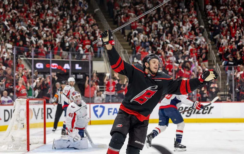 Carolina Hurricanes center Jesperi Kotkaniemi (82) reacts after a goal by teammate Shaye Gostisbehere (04) in the first period, to take a 1-0 lead against the Washington Capitals during Game 4 of their series on Monday, May 12, 2025 at Lenovo Center in Raleigh, N.C.
