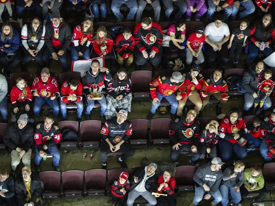Fans look up, waiting for ‘Hot Dogs from Heaven’, during the Ottawa Senators’ game against the Chicago Blackhawks at the Canadian Tire Centre on Saturday, Dec. 20, 2025.