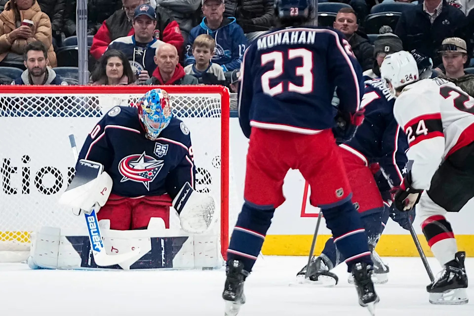 Columbus Blue Jackets goaltender Elvis Merzlikins (90) stops a shot from Ottawa Senators center Dylan Cozens (24) during the first period of the NHL hockey game at Nationwide Arena in Columbus on Jan. 20, 2026.