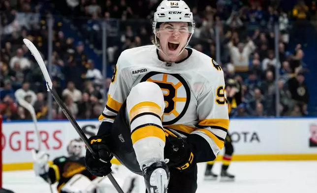 Boston Bruins' Fraser Minten (93) celebrates his game-winning goal against the Vancouver Canucks during overtime in an NHL hockey game in Vancouver, British Columbia, on Saturday, Jan. 3, 2026. (Ethan Cairns/The Canadian Press via AP)