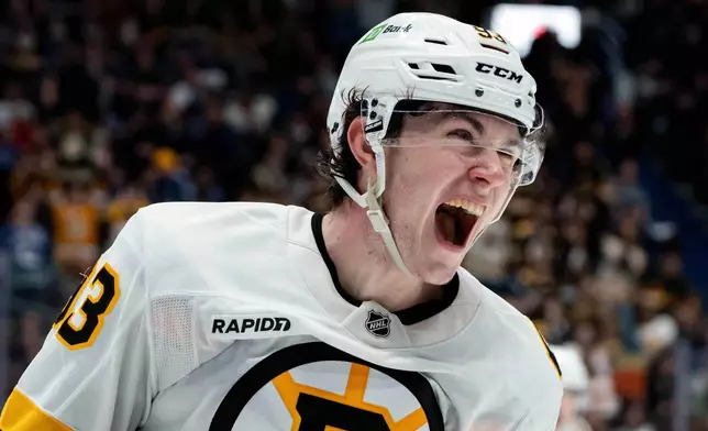 Boston Bruins' Fraser Minten (93) celebrates his game-winning goal against the Vancouver Canucks during overtime in an NHL hockey game in Vancouver, British Columbia, on Saturday, Jan. 3, 2026. (Ethan Cairns/The Canadian Press via AP)