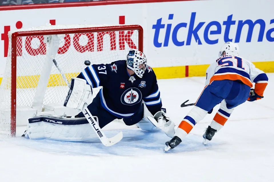 Emil Heineman scores on a penalty shot against goalie Connor Hellebuyck during the second period of the Islanders’ loss to the Jets. Terrence Lee-Imagn Images