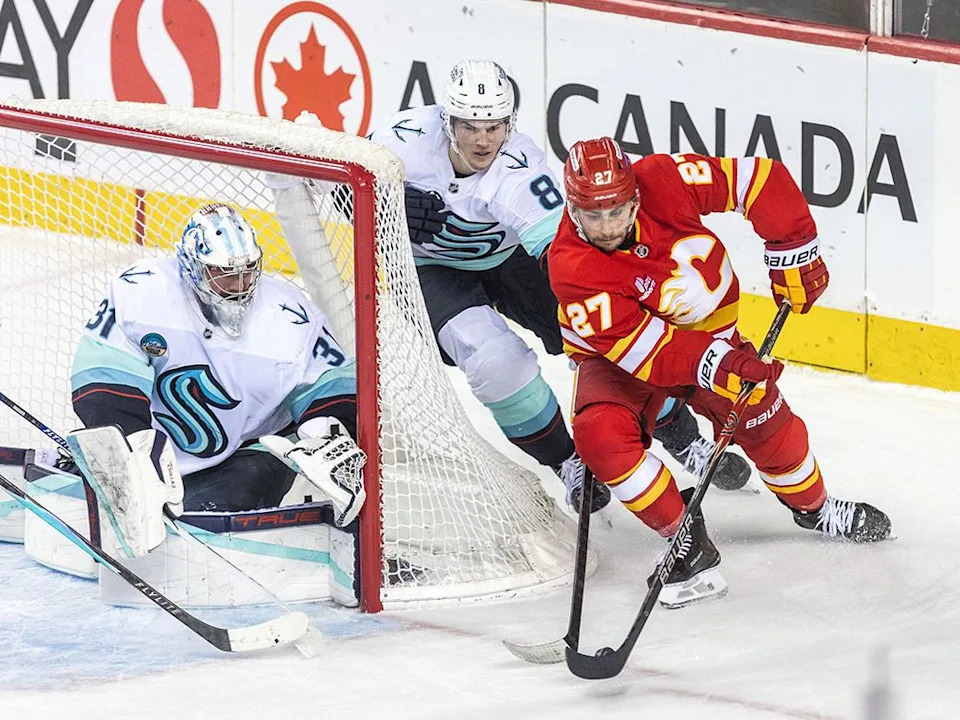  Flames forward Matt Coronato attempts a wrap-around shot during a game against the Seattle Kraken on Monday, Jan. 5.