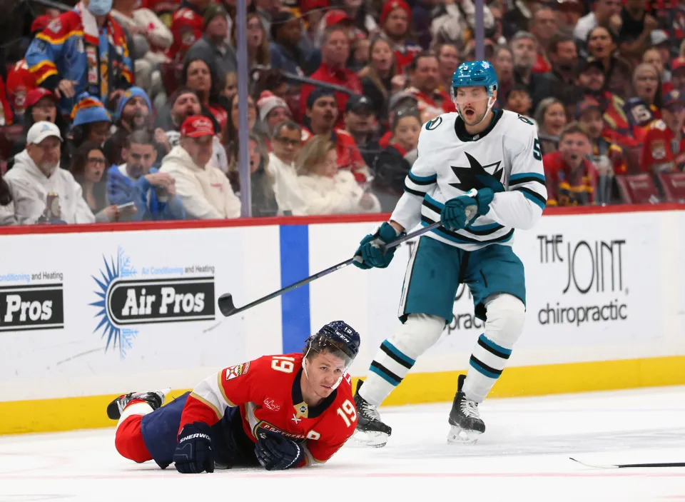 Vincent Desharnais #5 of the San Jose Sharks checks Matthew Tkachuk #19 of the Florida Panthers during the first period at Amerant Bank Arena on January 19, 2026 in Sunrise, Florida.