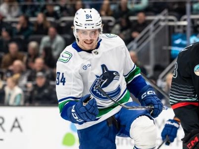 Dec 29, 2025; Seattle, Washington, USA; Vancouver Canucks forward Linus Karlsson (94) celebrates after scoring a goal during the first period against the Seattle Kraken at Climate Pledge Arena.