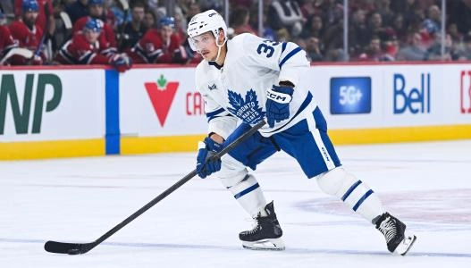 Sep 25, 2025; Montreal, Quebec, CAN; Toronto Maple Leafs defenseman Matt Benning (33) plays the puck against the Montreal Canadiens during the second period at Bell Centre