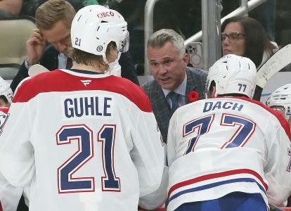 Nov 2, 2024; Pittsburgh, Pennsylvania, USA; Montreal Canadiens head coach Martin St. Louis (rear) talks to defenseman Kaiden Guhle (21) and center Kirby Dach (77) on the bench against the Pittsburgh Penguins during the third period at PPG Paints Arena. Mandatory Credit: Charles LeClaire-Imagn Images