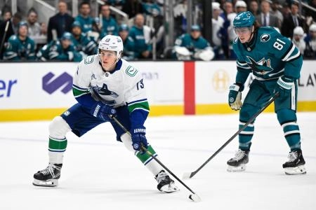 Nov 28, 2025; San Jose, California, USA; Vancouver Canucks left winger Lukas Reichel (73) controls the puck against the San Jose Sharks in the first period at SAP Center at San Jose.