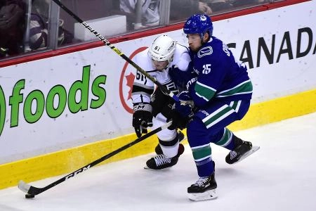Mar 28, 2019; Vancouver, British Columbia, CAN; Vancouver Canucks forward Ryan Spooner (15) skates against Los Angeles Kings defenseman Sean Walker (61) during the third period at Rogers Arena.