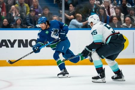 Jan 2, 2026; Vancouver, British Columbia, CAN; Vancouver Canucks forward Kiefer Sherwood (44) shoots against the Seattle Kraken in the second period at Rogers Arena.