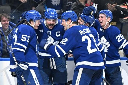 Jan 1, 2026; Toronto, Ontario, CAN; Toronto Maple Leafs forward Auston Matthews (34) celebrates with forwards Easton Cowan (53) and Nick Robertson (89) and defensemen Jake McCabe (22) and Troy Stecher (28) after scoring his third goal of the game against the Winnipeg Jets in the third period at Scotiabank Arena. Mandatory Credit: Dan Hamilton-Imagn Images
