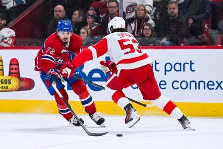 January 10, 2026; Montreal, Quebec, Canada; Detroit Red Wings defenseman Moritz Seider (53) protects the puck against Montreal Canadiens defenseman Arber Xhekaj (72) during the third period at the Bell Centre.