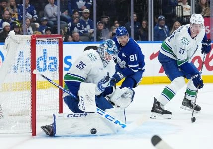Jan 10, 2026; Toronto, Ontario, CAN; Vancouver Canucks goaltender Thatcher Demko (35) stops the puck as Toronto Maple Leafs center John Tavares (91) looks for a rebound during the first period at Scotiabank Arena.