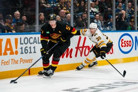Jan 3, 2026; Vancouver, British Columbia, CAN; Boston Bruins forward Morgan Geekie (39) pursues Vancouver Canucks defenseman Tyler Myers (57) in the first period at Rogers Arena.
