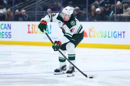Jan 8, 2026; Seattle, Washington, USA; Minnesota Wild defenseman Quinn Hughes (43) passes in the third period against the Seattle Kraken at Climate Pledge Arena.