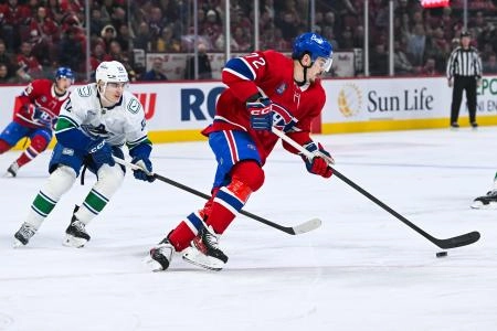 Jan 12, 2026; Montreal, Quebec, CAN; Montreal Canadiens defenseman Arber Xhekaj (72) plays the puck against Vancouver Canucks left wing Liam Ohgren (92) during the first period at Bell Centre. Mandatory Credit: David Kirouac-Imagn Images