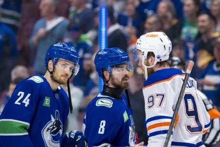 May 20, 2024; Vancouver, British Columbia, CAN; Vancouver Canucks forward Pius Suter (24) and forward Conor Garland (8) shake hands with Edmonton Oilers forward Connor McDavid (97) after the Edmonton victory in game seven of the second round of the 2024 Stanley Cup Playoffs at Rogers Arena.