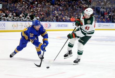 Jan 17, 2026; Buffalo, New York, USA; Buffalo Sabres right wing Jack Quinn (22) tries to block a shot by Minnesota Wild defenseman Quinn Hughes (43) during the third period at KeyBank Center.