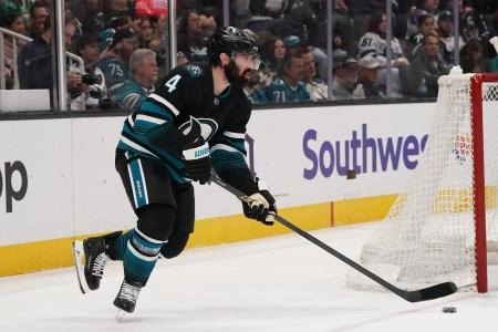 Jan 6, 2026; San Jose, California, USA; San Jose Sharks defenseman Nick Leddy (4) controls the puck during against the Columbus Blue Jackets in the first period at SAP Center at San Jose. Mandatory Credit: David Gonzales-Imagn Images