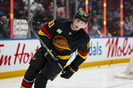 Jan 17, 2026; Vancouver, British Columbia, CAN; Vancouver Canucks defenseman Victor Mancini (90) skates during warm ups prior to a game against the Edmonton Oilers at Rogers Arena.
