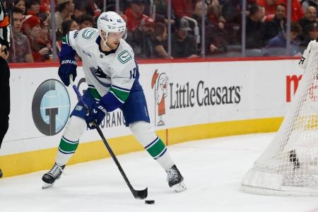 Jan 8, 2026; Detroit, Michigan, USA; Vancouver Canucks center Elias Pettersson (40) skates with the puck in the first period against the Detroit Red Wings at Little Caesars Arena.