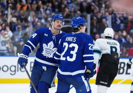 Nov 5, 2025; Toronto, Ontario, CAN; Toronto Maple Leafs left wing Matthew Knies (23) scores an empty net goal and celebrates with center Auston Matthews (34) against the Utah Mammoth during the third period at Scotiabank Arena. Mandatory Credit: Nick Turchiaro-Imagn Images