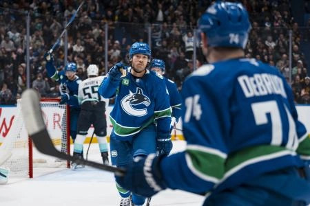 Jan 2, 2026; Vancouver, British Columbia, CAN; Vancouver Canucks forward Kiefer Sherwood (44) and forward Jake DeBrusk (74) celebrate Sherwood's goal against the Seattle Kraken in the second period at Rogers Arena.