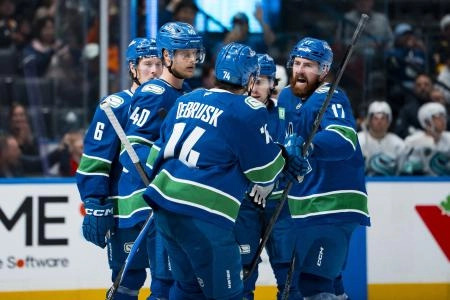 Sep 26, 2025; Vancouver, British Columbia, CAN; Vancouver Canucks forward Brock Boeser (6), forward Elias Pettersson (40), forward Jake DeBrusk (74), defenseman Quinn Hughes (43) and defenseman Filip Hronek (17) celebrate Hronek's goal against the Seattle Kraken in the third period at Rogers Arena.