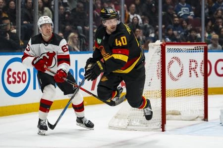 Jan 23, 2026; Vancouver, British Columbia, CAN; New Jersey Devils forward Jesper Bratt (63) trips up Vancouver Canucks forward Elias Pettersson (40) in the first period at Rogers Arena.