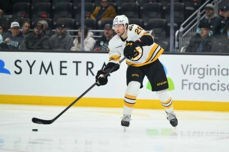 Jan 6, 2026; Seattle, Washington, USA; Boston Bruins defenseman Andrew Peeke (26) passes the puck against the Seattle Kraken during the second period at Climate Pledge Arena. Mandatory Credit: Steven Bisig-Imagn Images