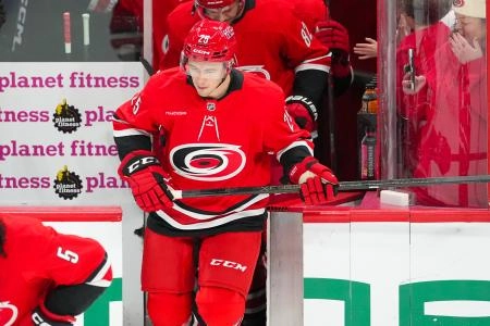 Dec 29, 2025; Raleigh, North Carolina, USA; Carolina Hurricanes defensemen Gavin Bayreuther (25) comes out onto the ice for the warmups before the game against the New York Rangers at Lenovo Center. Mandatory Credit: James Guillory-Imagn Images