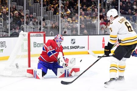 Jan 24, 2026; Boston, Massachusetts, USA; Montreal Canadiens goaltender Sam Montembeault (35) makes a save in front of Boston Bruins defenseman Mason Lohrei (6) during the first period at TD Garden. Mandatory Credit: Bob DeChiara-Imagn Images