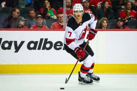Jan 19, 2026; Calgary, Alberta, CAN; New Jersey Devils defenseman Dougie Hamilton (7) skates with the puck against the Calgary Flames during the overtime period at Scotiabank Saddledome. Mandatory Credit: Sergei Belski-Imagn Images