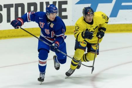 Aug 2, 2024; Plymouth, MI, USA; USA's forward Colin Ralph (11) battles for position with Sweden's forward Melvin Fernstrom (12) during the second period of the 2024 World Junior Summer Showcase at USA Hockey Arena.
