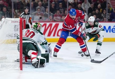 Jan 20, 2026; Montreal, Quebec, CAN; Minnesota Wild goalie Jesper Wallstedt (30) stops Montreal Canadiens forward Nick Suzuki (14) during the second period at the Bell Centre. Mandatory Credit: Eric Bolte-Imagn Images